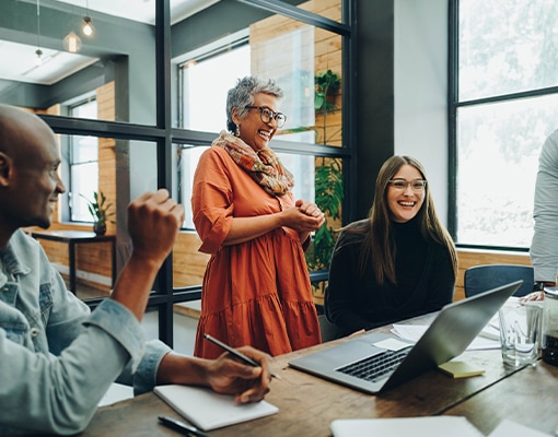 a diverse room full of coworkers who are laughing