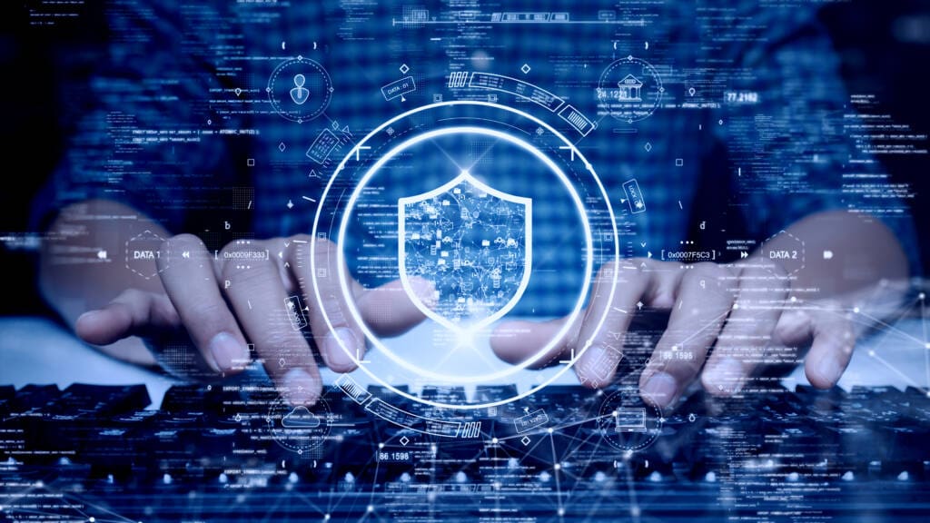 Hands typing on a keyboard with a digital overlay featuring a shield symbol at the center, surrounded by icons representing cybersecurity concepts such as padlocks, data protection, and network security. The background suggests cloud security elements and AWS LandingZone deployment within a digital interface.